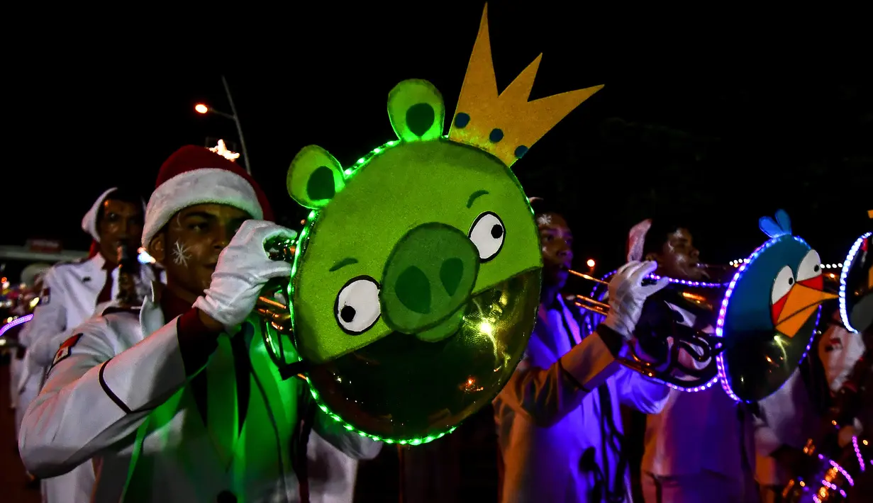 Seorang pria memainkan terompet selama parade Natal di Panama City (16/12). Warga Panama tengah mempersiapkan diri menyambut datangnya Natal 2018 yang jatuh pada tanggal 25 Desember. (AFP Photo/Luis Acosta)