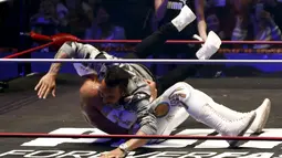 Pebalap F1 dari tim Mercedes GP, Lewis Hamilton berusaha menjatuhkan pegulat yang bintang WWE di Coliseo Arena, Mexico City, (28/10/2015). (Reuters/Henry Romero)