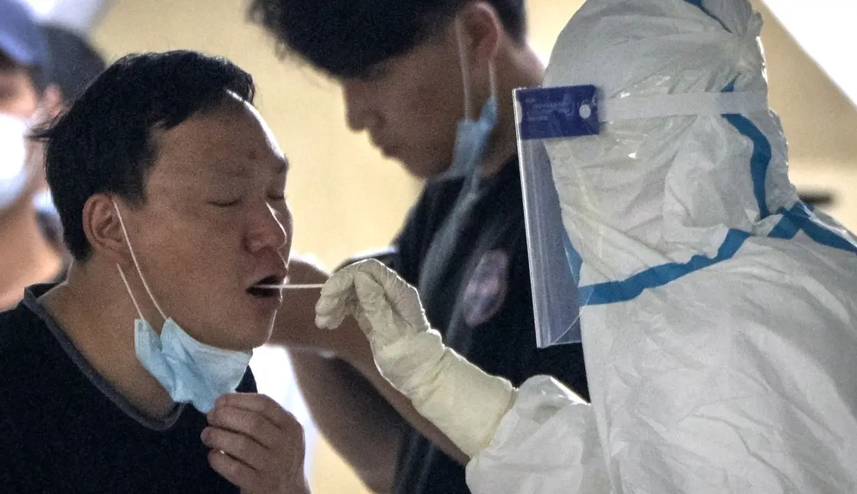 <p>Seorang pekerja mengenakan baju pelindung mengambil swab untuk tes COVID-19 di fasilitas pengujian virus corona di Beijing, China, Sabtu (23/4/2022). Beijing dalam keadaan waspada setelah 10 siswa sekolah menengah dinyatakan positif COVID-19 pada hari Jumat, yang menurut pejabat kota sebagai putaran awal pengujian. (AP Photo/Mark Schiefelbein)</p>