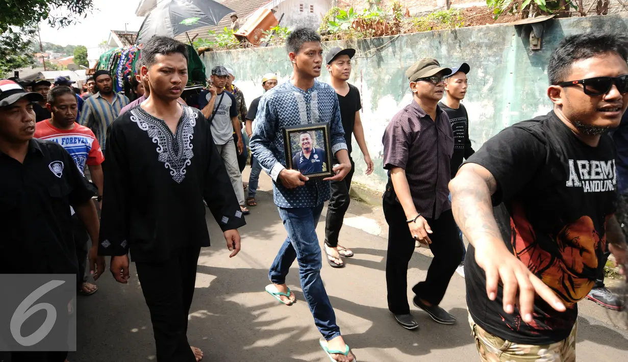 Adik kandung Achmad Kurniawan, Kurnia Meiga (tengah) mengantar jenazah sang kakak menuju pemakaman di kawasan Cijantung, Jakarta, Rabu (11/1). Kiper Arema FC, Achmad Kurniawan wafat di usia 37 tahun. (Liputan6.com/Helmi Fithriansyah)