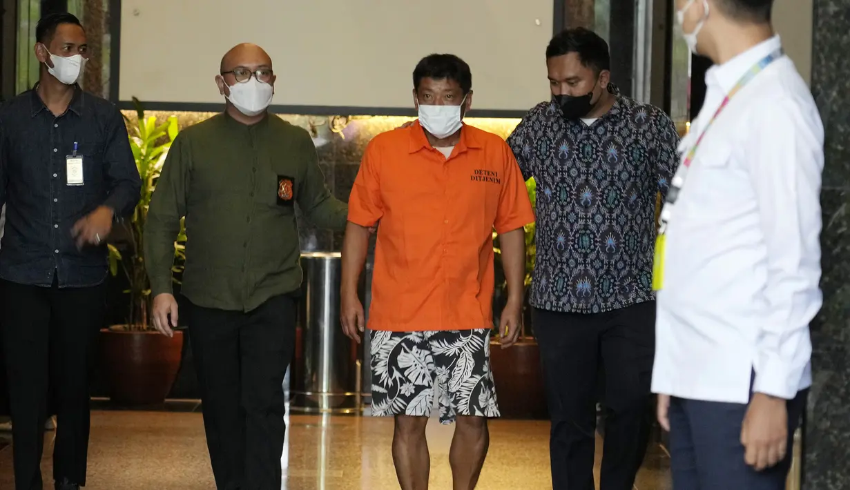 Petugas imigrasi mengawal Mitsuhiro Taniguchi (47) sebelum konferensi pers di Kantor Imigrasi, Jakarta, Indonesia, Rabu (8/6/2022). Mitsuhiro Taniguchi bakal ditindaklanjuti dengan Undang-Undang Keimigrasian. (AP Photo/Achmad Ibrahim)