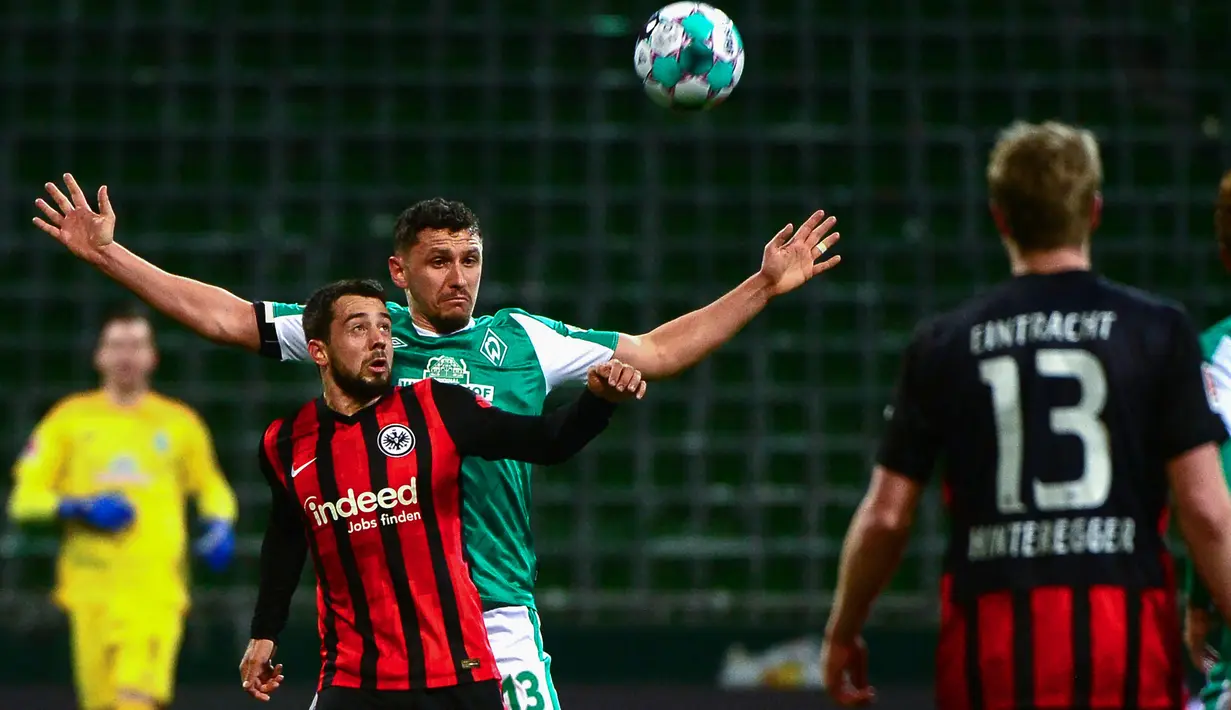 Gelandang Eintracht Frankfurt, Amin Younes (kiri) berebut bola dengan bek Werder Bremen, Milos Veljkovic dalam laga lanjutan Liga Jerman 2020/21 pekan ke-23 di Weserstadion, Bremen, Jumat (26/2/2021). Eintracht Frankfurt kalah 1-2 dari Werder Bremen. (AFP/Patrik Stollarz/Pool)