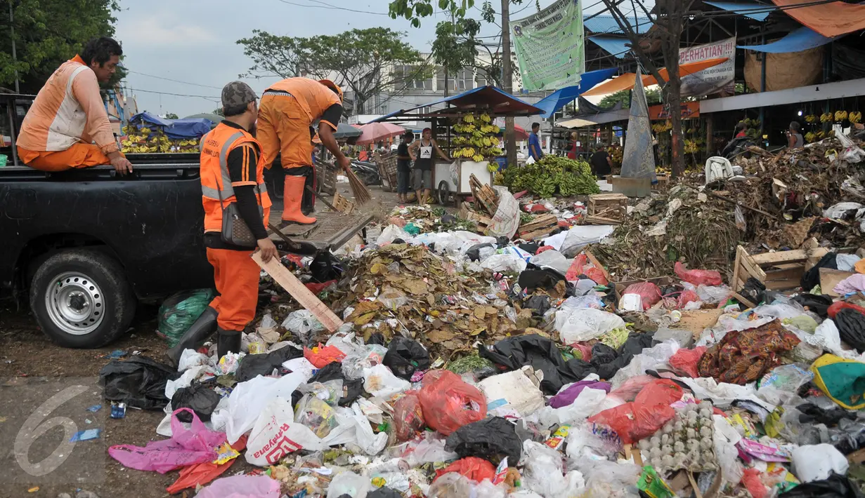Petugas PPSU merapihkan sampah di tempat pembuangan sampah (TPS) di Blok C Pasar Minggu, Jakarta, Minggu (30/4). DPRD DKI meminta pemindahan TPS dekat Lokasi Binaan (Lokbin) Blok C Pasar Minggu dipercepat karena tidak layak. (Liputan6.com/Yoppy Renato)