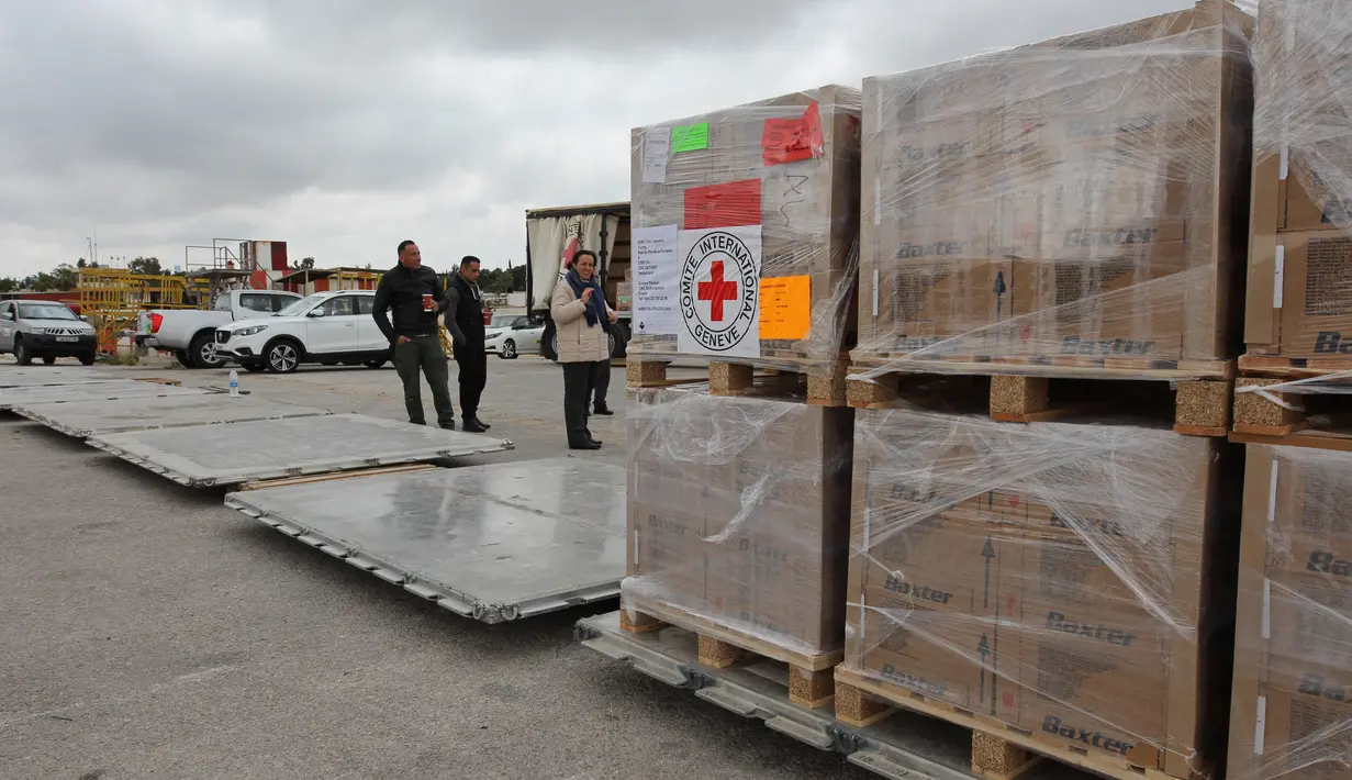 Gambar selebaran yang dirilis oleh Komite Palang Merah Internasional (ICRC) pada 30 April 2023, menunjukkan anggota ICRC menyiapkan kotak bantuan kemanusiaan di Amman, sebelum memuatnya ke pesawat tujuan Port Sudan. (Photo by ICRC / AFP)