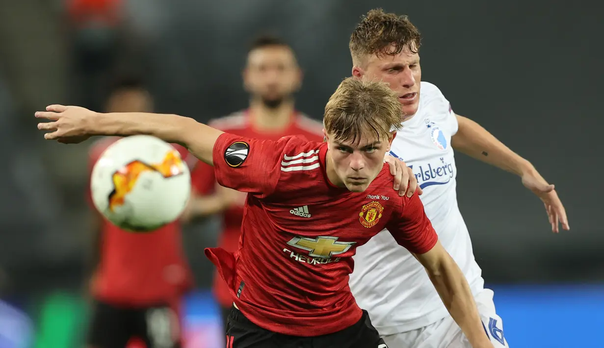 Bek Manchester United, Brandon Williams, berebut bola dengan gelandang Copenhagen, Pep Biel, pada laga perempat final Liga Europa di RheinEnergie Stadion, Jerman, Selasa (11/8/2020) dini hari WIB. Manchester United menang 1-0 atas Copenhagen. (AFP/Wolfgang Rattay/pool)
