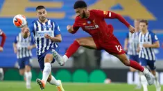 Bek Liverpool, Joe Gomez menendang bola menjauh dari pemain Brighton & Hove Albion, Neal Maupay (kiri) pada lanjutan pertandingan Liga Inggris di Stadion Falmer, Kamis (9/7/2020) dini hari WIB. Liverpool berhasil kalahkan Brighton dengan skor 3-1. (AP Photo/Paul Childs,Pool)