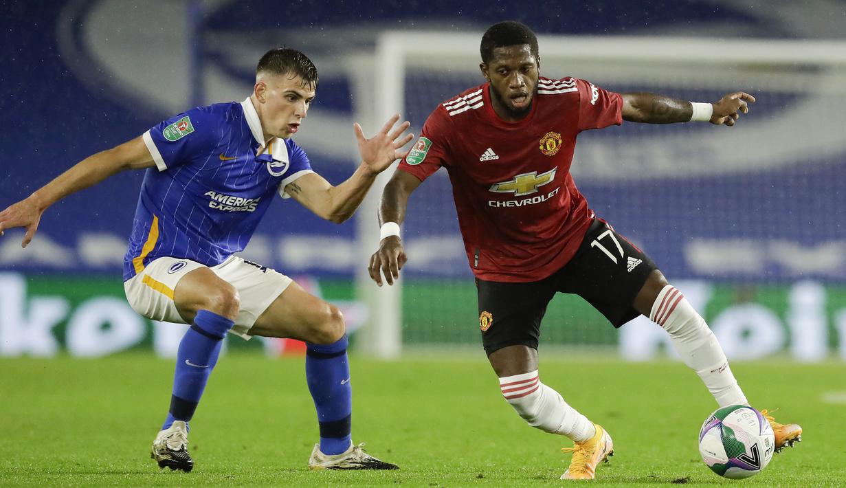 Gelandang Manchester United, Fred, berebut bola dengan gelandang Brighton, Jayson Molumby, pada laga Carabao Cup di Stadion Falmer, Kamis (1/10/2020) dini hari WIB. Manchester United menang 3-0 atas Brighton. (Matt Dunham/Pool via AP)