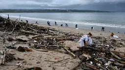 Mereka terdorong untuk ikut membersihkan sampah yang menumpuk di pantai Kedonganan, Badung, Bali. (SONNY TUMBELAKA/AFP)