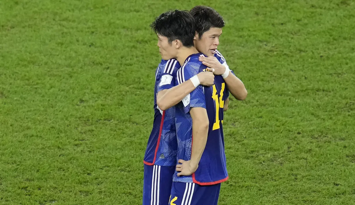 Pemain Jepang, Hiroki Sakai, berusaha menenangkan Takehiro Tomiyasu usai ditaklukkan Kroasia pada babak 16 besar Piala Dunia 2022. Tim Samurai Biru kalah adu penalti dengan skor 1-3 dari Kroasia. (AP/Ricardo Mazalan)
