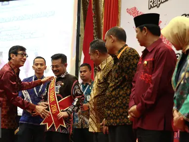 Menteri Hukum dan HAM (Menkumham), Yasonna Laoly memberikan piagam kepada pemenang Anugerah Nawacita Legislasi 2016 serta menutup raker peraturan perundangan-undangan di Jakarta, Jumat (24/6). (Liputan6.com/Faizal Fanani)