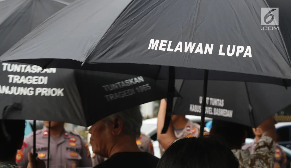 Aktivis saat aksi Kamisan di depan Istana Merdeka, Jakarta, Kamis (13/12). Mereka meminta pemerintah segera menyelesaikan kasus-kasus pelanggaran HAM di Indonesia. (Liputan6.com/Helmi Fithriansyah)