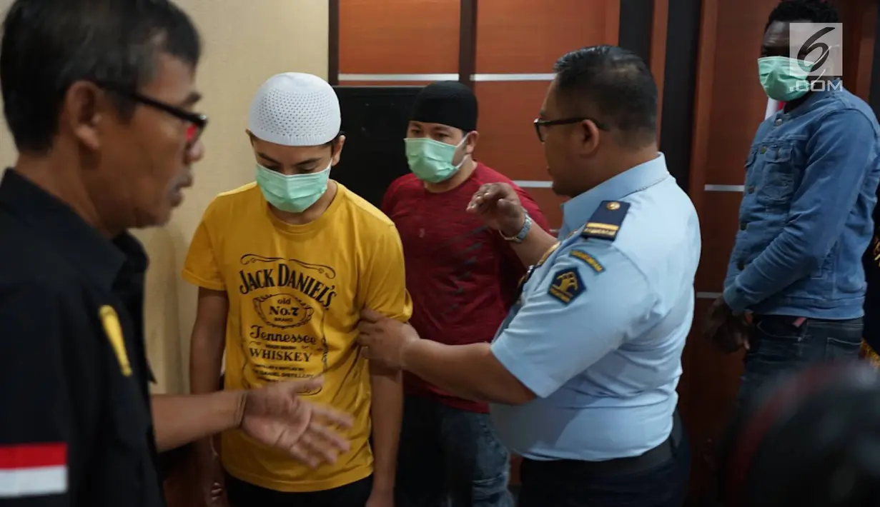 Tiga WNA yang terjaring razia di salah satu hotel kawasan Sawah Besar saat konferensi pers di Kantor Imigrasi Kelas I Non TPI Jakarta Pusat, Kamis (8/8/2019). Dua di antaranya pencari suaka HA (17) dan SM (15) asal Afghanistan, sementara satunya berasal dari Nigeria. (Liputan6.com/Immanuel Antonius)