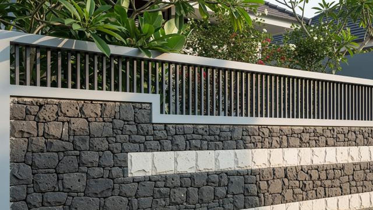 Pagar Semi Tertutup dengan Batu Alam Dominan/Model Pagar Rumah Kombinasi Besi Hollow dan Batu Alam (Sumber: gemini.com)