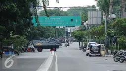 Sejumlah kendaraan petugas berjaga di sekitar perempatan jalan Wahid Hasyim Jakarta atau lokasi tempat pengeboman, Kamis (14/1/2016). Polisi mencurigai seorang melakukan aksi bom bunuh diri. (Liputan6.com/Helmi Fitriansyah)