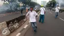 Massa berlari saat polisi menembakkan gas air mata di depan gedung KPK, Jakarta, Jumat (20/5). Aksi menuntut KPK untuk segera mengusut keterlibatan Ahok di RS Sumber Waras ini berakhir ricuh. (Liputan6.com/Yoppy Renato)