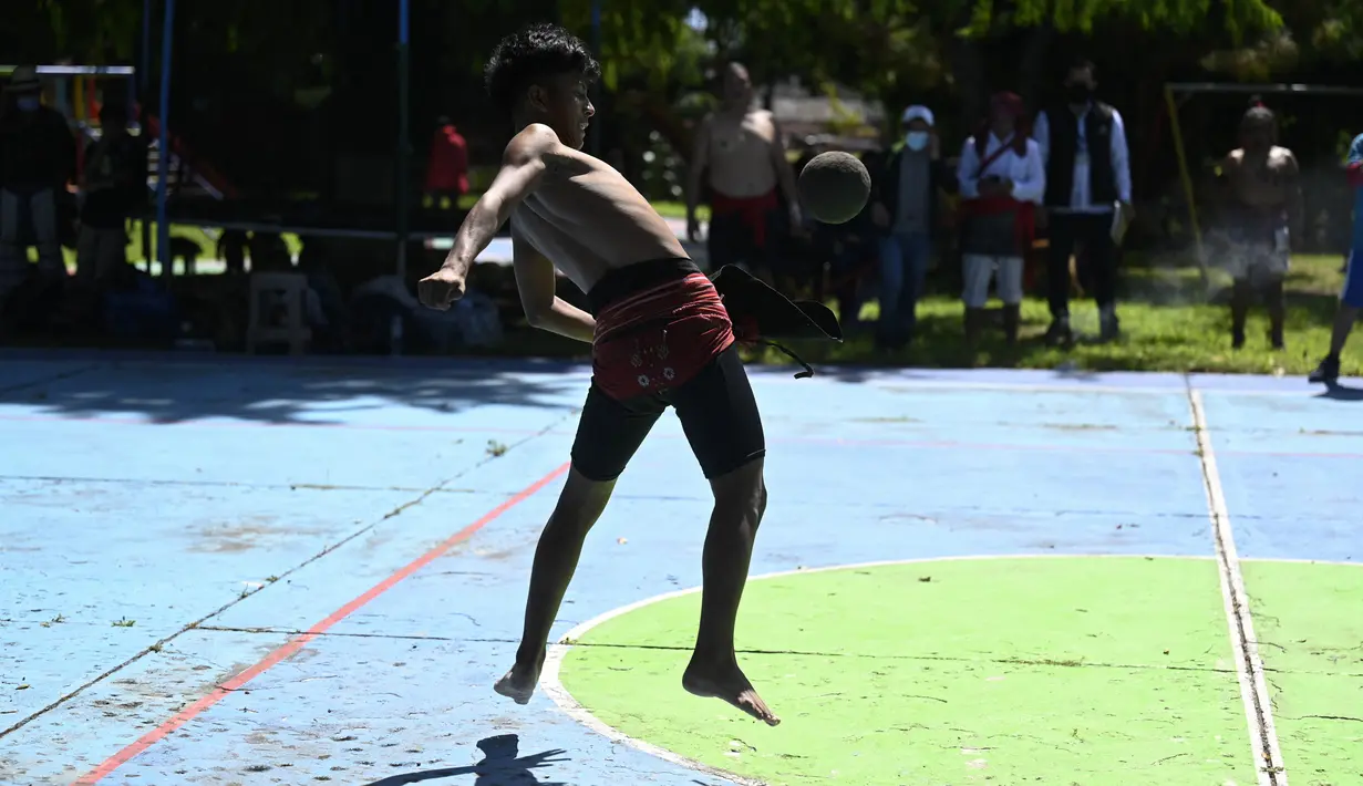 Seorang penduduk Asli Guatemala memainkan permainan bola Maya di San Juan La Laguna di Solola, Guatemala City, pada 18 September 2021. Permainan bola maya ini merupakan permainan bola yang dipukul menggunakan bagian pinggul. (Johan ORDONEZ/AFP)