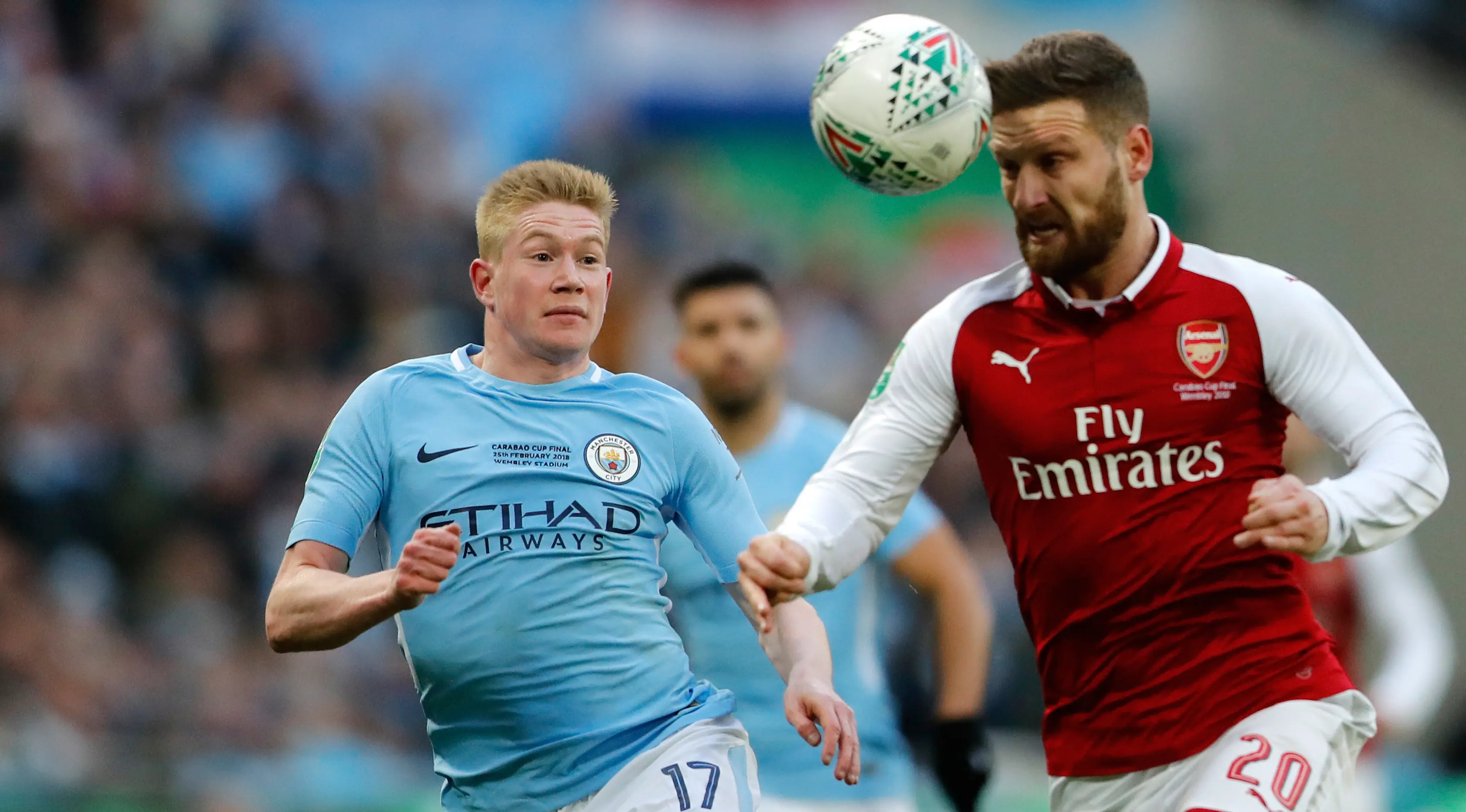 Pemain Manchester City, Kevin De Bruyne berebut bola dengan pemian Arsenal, Shkodran Mustafi dalam laga final Piala Liga Inggris di Stadion Wembley, Minggu (25/2) (AP/Frank Augstein)