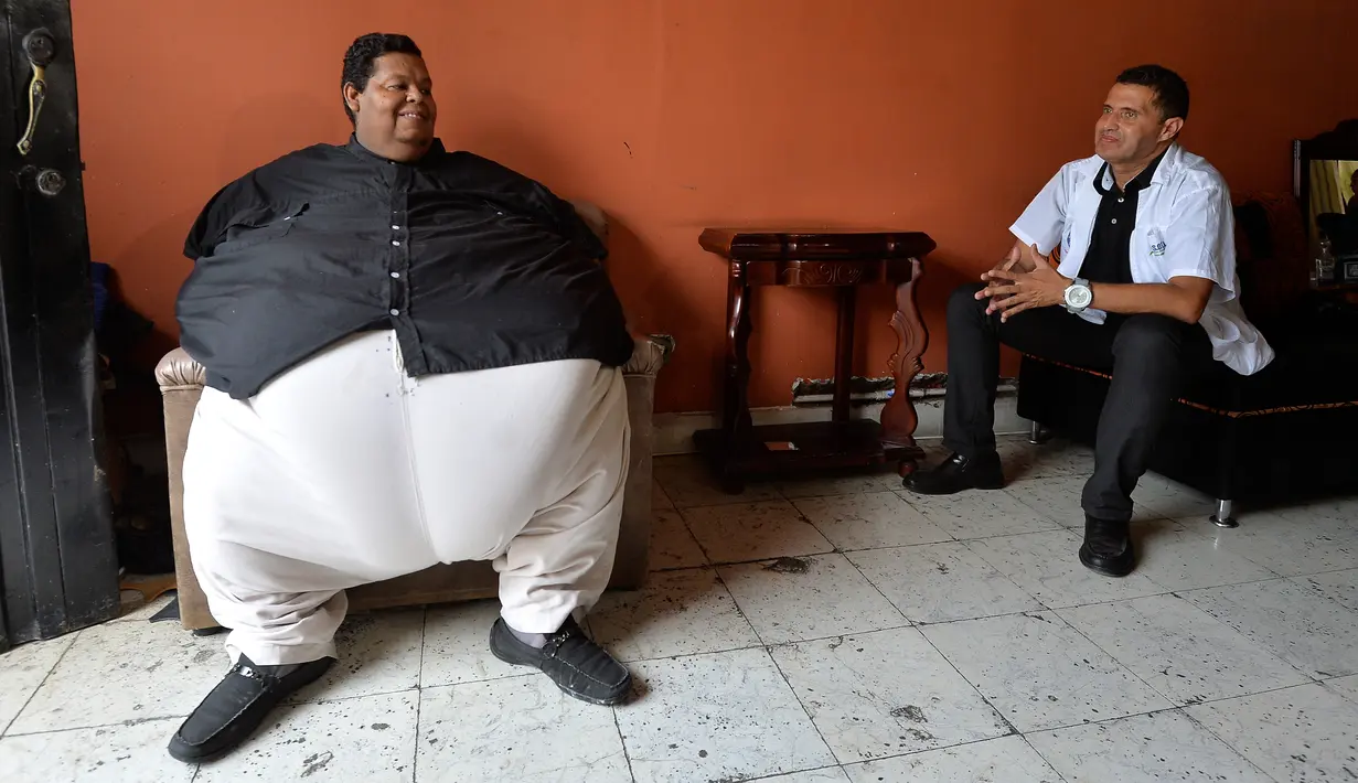 Oscar Vasquez Morales (44) berbincang dengan pengelola Yayasan Jantung Antiochian Gorditos di Palmira, Kolombia, 19 Maret 2016. Untuk memindahkan Oscar ke rumah sakit diperlukan 20 orang kru dan sebuah satu truk pemadam kebakaran. (AFP PHOTO/Luis ROBAYO)