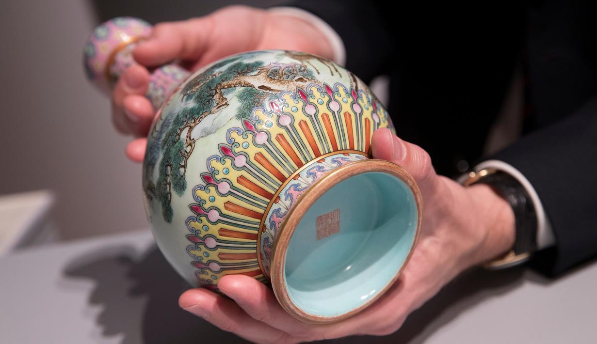 Vas China antik berusia ratusan tahun diperlihatkan di rumah lelang Sotheby, Paris, Selasa (22/5). Vas yang diyakini berasal dari masa Dinasti Qing di abad ke-18 itu ditafsir bernilai lebih dari 500.000 euro (sekitar Rp 8,3 miliar). (AFP/Thomas SAMSON)