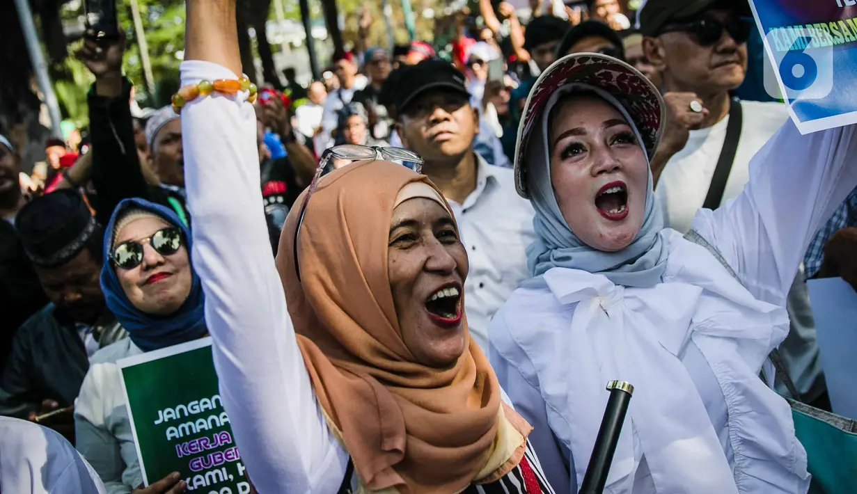 Massa Gentari (Genarasi Cinta Negeri) menggelar aksi dukungan kepada Gubernur DKI Jakarta, Anies Baswedan di depan Balai Kota DKI Jakarta, Selasa (14/1/2020). Mereka mengawal Anies Baswedan agar menyelesaikan program kerja sebagai Gubernur DKI terkait penanganan banjir. (Liputan6.com/Faizal Fanani)