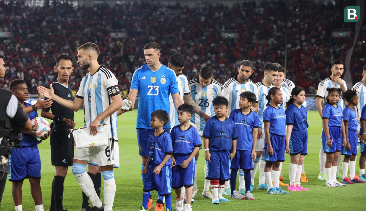 <p>Cucu Presiden Joko Widodo (Jokowi), Jan Ethes, tampak mendampingi kiper Timnas Argentina, Emiliano Martinez, sebagai player escort dalam laga Timnas Indonesia kontra Argentina di laga FIFA Matchday yang digelar di Stadion Utama Gelora Bung Karno (SUGBK), Senayan, Jakarta, Senin (19/6/2023). (Bola.com/Abdul Aziz)</p>