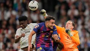 Kiper Barcelona, Wojciech Szczesny, meninju bola melewati Aurelien Tchouameni dari Real Madrid dan Eric Garcia dari Barcelona dalam pertandingan La Liga di Santiago Bernabeu, Minggu, 26 Oktober 2025. (AP Photo/Bernat Armangue)