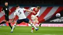 Gelandang Arsenal, Emile Smith Rowe (tengah) menembak ke arah gawang yang membentur mistar saat berusaha dihalangi gelandang Tottenham Hotspur Pierre-Emile Hojbjerg dalam derby London Utara Liga Inggris di Emirates Stadium, Minggu (14/3/2021). Arsenal menang 2-1 atas Tottenham. (DAN MULLAN/POOL/AFP)