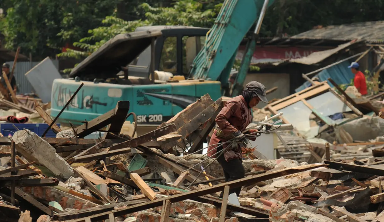 Pemulung mengais besi sisa bangunan kios pedagang Terminal Depok, Jawa Barat yang dibongkar, Rabu (8/10/2014). (Liputan6.com/Helmi Fithriansyah)
