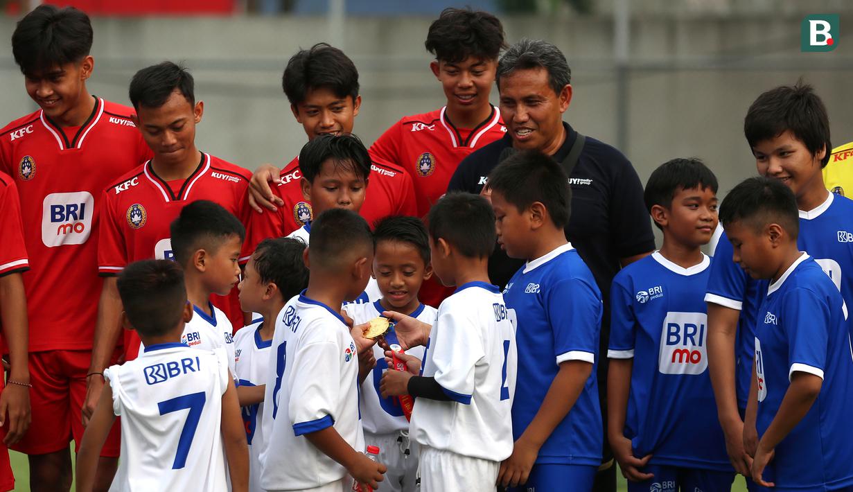 <p>Sejumlah peserta kegiatan BRImo Future Garuda&nbsp;memegang medali emas SEA Games 2023 milik pelatih Timnas Indonesia U-16, Bima Sakti&nbsp;di Lapangan BRILiaN Stadium, Jalan Fatmawati Raya, Jakarta, Selasa (30/05/2023). (Bola.com/Bagaskara Lazuardi)</p>