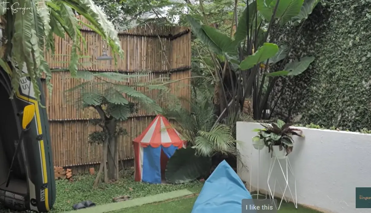 Rumah yang dikelilingi pohon besar ini disewakan saat Ammar Zoni mendekam di penjara. Untuk membuat semakin dekat dengan alam, pagar juga menggunakan bambu.  Sedangkan tembok dibuat tinggi sehingga keamanan terjaga. Potret berikut diambil dari kanal Youtube The Sungkar yang tayang tiga tahun silam. [Youtube/The Sungkars]