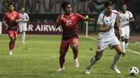 Pemain Indonesia, Ilham Udin, berebut bola dengan pemain Palestina, Michelmilad Termanini, pada laga Asian Games di Stadion Patriot, Jawa Barat, Rabu (15/8/2018). Indonesia takluk 1-2 dari Palestina. (Bola.com/Vitalis Yogi Trisna)