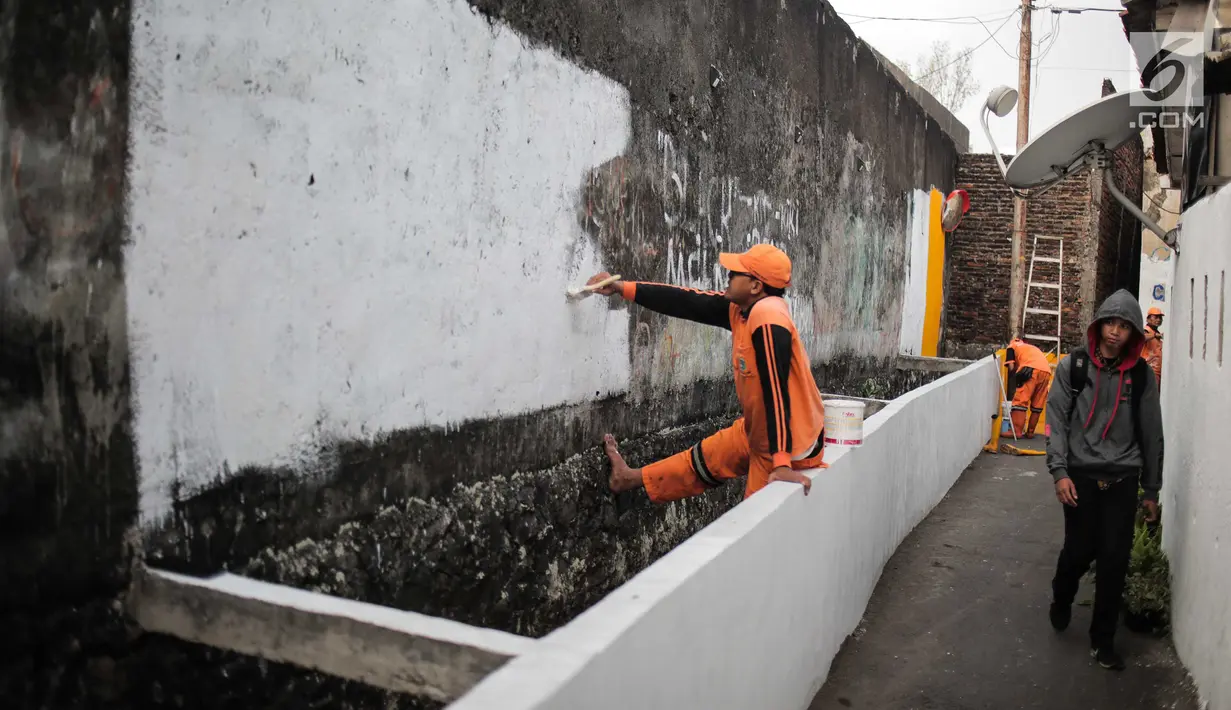 Petugas PPSU menyelesaikan pengerjaan jalur peningkatan aksesibilitas jalan lokal dan kampung menuju Stasiun MRT di Gang Teladan, Cipete Raya, Jakarta, Senin (2/9/2019). Hal ini untuk meningkatkan keamanan bagi pejalan kaki dan pesepeda menuju Stasiun MRT Cipete Raya. (Liputan6.com/Faizal Fanani)
