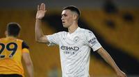 Gelandang Manchester City, Phil Foden, menyumbangkan satu gol sekaligus membantu timnya menang 3-0 atas Wolverhampton Wanderers pada laga pekan kedua Premier League, di Molineux Stadium, Selasa (22/9/2020) dini hari WIB. (Stu Forster/Pool via AP)
