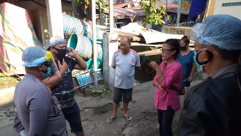 Gugus Tugas Covid-19 Kota Manado bersama aparat kepolisian berkomunikasi dengan pihak keluarga untuk mengevakuasi pasien Covid-19.