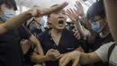 Seorang pria yang diduga mata-mata China berteriak saat diikat oleh pemrotes pro-demokrasi saat unjuk rasa di bandara internasional Hong Kong (13/8/2019). Pria ini jadi bulan-bulanan demonstran saat unjuk rasa di bandara Hong Kong. (AP Photo/Vincent Yu)