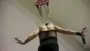 Wanita dikaitkan sebuah besi dan diangkat ke udara selama acara Tattoo and Suspension Convention di Valparaiso, Chili, (8/11/2015). Acara ini merupakan kegiatan untuk para penyuka tato dan modifikasi tubuh di Chili.  (REUTERS/Rodrigo Garrido)