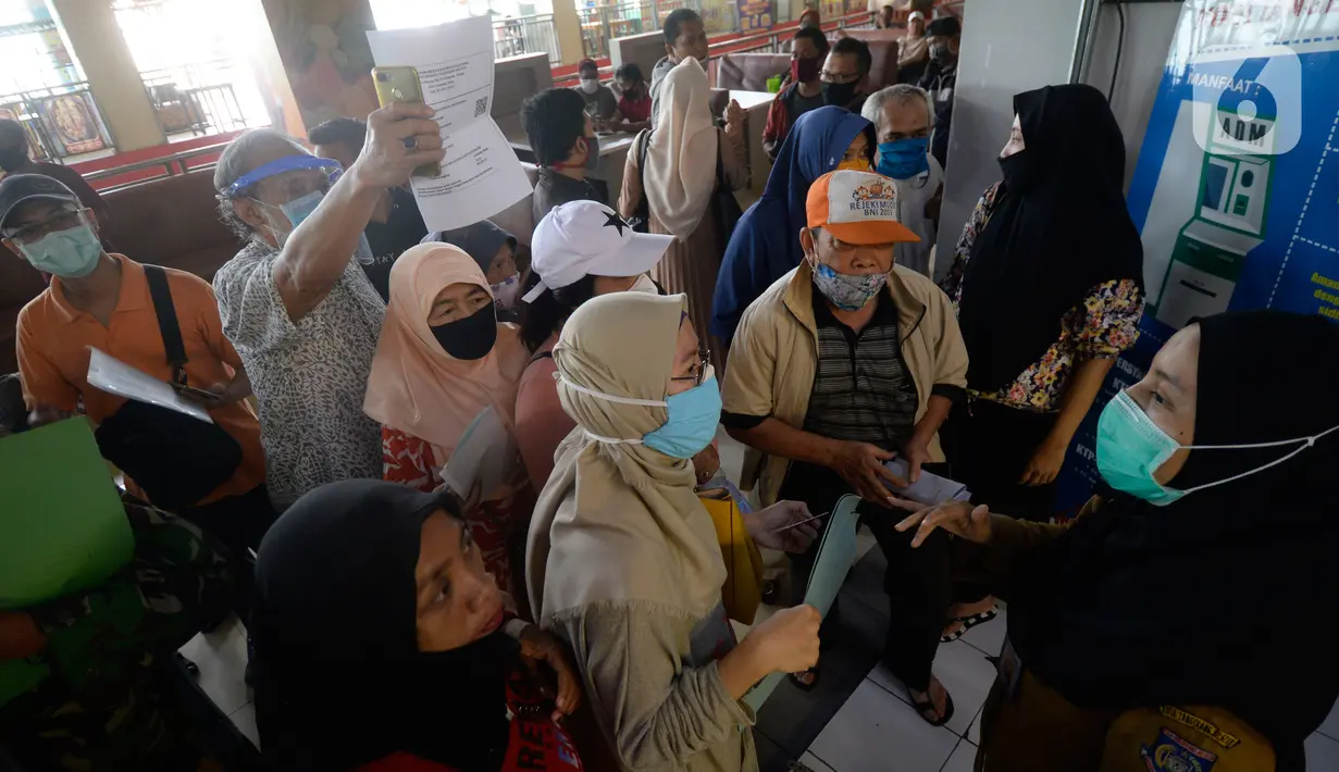 Petugas memberikan penjelasan kepada warga yang akan melakukan pencetakan di mesin Anjungan Dukcapil Mandiri (ADM) di Pamulang Square, Tangerang Selatan, Senin (15/9/2020). Warga dapat melakukan pelayanan kependudukan tanpa perlu lagi datang ke kantor Disdukcapil di ADM. (merdeka.com/Dwi Narwoko)