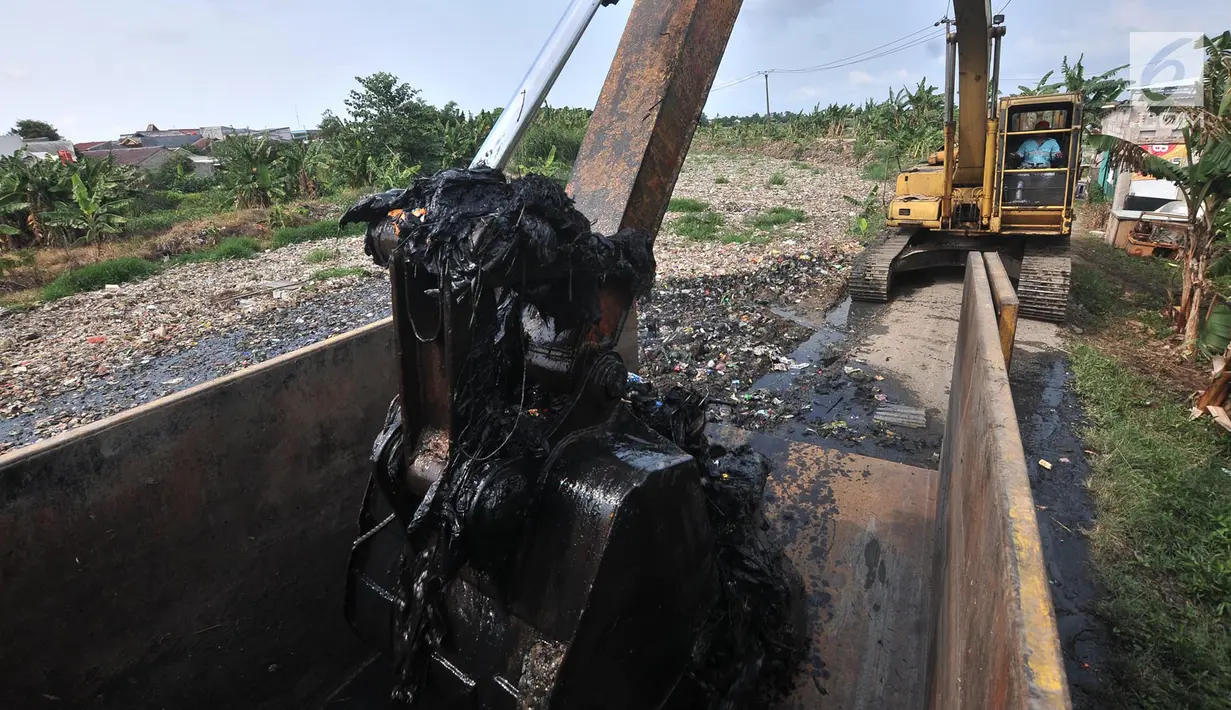 Alat berat saat mengeruk sampah yang memenuhi Kali Pisang Batu, Tarumajaya, Bekasi, Jawa Barat, Rabu (9/1). Lautan sampah yang memenuhi Kali Pisang Batu ini diduga berasal dari aliran kali di wilayah kota Bekasi. (Merdeka.com/Iqbal S. Nugroho)