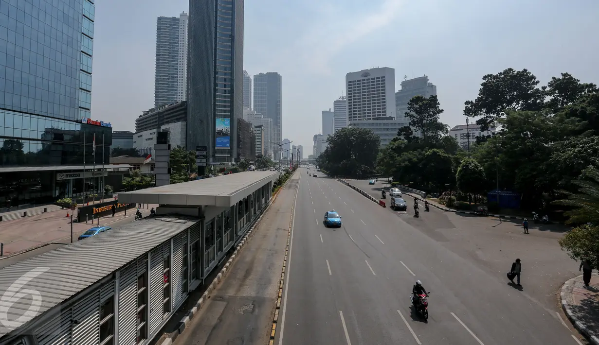 Ruas jalan protokol terlihat lengang di kawasan Jalan Thamrin mengarah ke Sudirman, Jakarta, Kamis (18/6/2015). Pada hari pertama puasa Ramadan 1436 H, beberapa titik jalan terlihat lengang dan sepi dari aktivitas warga. (Liputan6.com/Faizal Fanani)