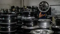 Seorang pekerja membawa velg alloy di sebuah bengkel di Ampang, di pinggiran kota Kuala Lumpur, Malaysia (18/7). Bengkel di pinggiran kota Kuala Lumpur telah menghasilkan lebih dari 200 pelek yang telah diperbaharu. (AFP Photo/Mohd Rasfan)