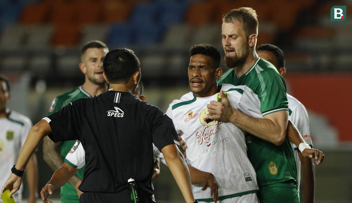 Gelandang PS Sleman, Maslac Mario (kanan) melerai gelandang Persebaya Surabaya, Ricky R Kambuaya (tengah) saat memprotes hasil keputusan wasit dalam laga Grup C Piala Menpora 2021 di Stadion Si Jalak Harupat, Bandung, Rabu (7/4/2021). PS Sleman menang 1-0 atas Persebaya. (Bola.com/Ikhwan Yanuar)
