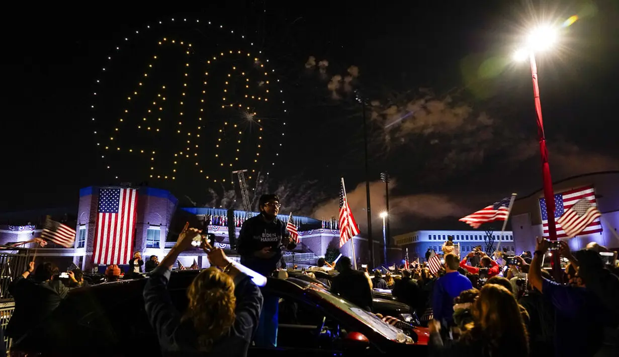 Drone membentuk angka 46 saat Presiden terpilih Joe Biden dan Wakil Presiden terpilih Kamala Harris menyampaikan pidato kemenangan Pilpres AS 2020 di Wilmington, Delaware, Amerika Serikat, Sabtu (7/11/2020). Joe Biden dan Kamala Harris memenangkan Pilpres AS 2020. (AP Photo/Andrew Harnik)