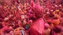 Umat Hindu merayakan Holi, festival warna musim semi, di sebuah kuil di desa Nandgaon, negara bagian Uttar Pradesh, 5 Maret 2020. Ribuan orang India menyambut musim semi pada Kamis (5/3) dengan merayakan Festival Holi yang identik dengan aksi saling melemparkan bubuk warna warni. (Money SHARMA/AFP)