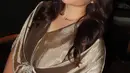 Jovita Karen mengenakan kaftan warna gold dengan aksen beads silver di bagian perut, dipadukan aksesori kalung dan gelangnya. [@jovitakaren]