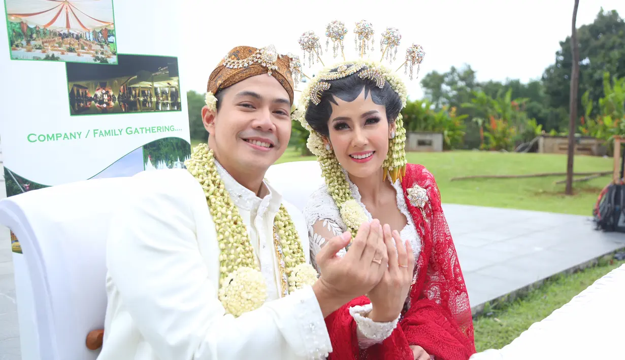 Keceriaan terpancar dari pengantin baru Ardina Rasti dan suami, Arie Dwi Andika usai melakukan akad nikah. Pasangan ini baru memperlihatkan cincin kawin yang tersemat di jari keduanya. (Daniel Kampua/Bintang.com)