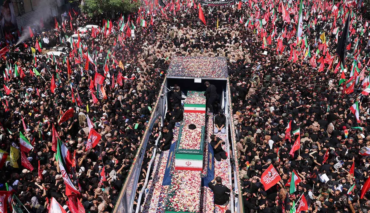 Kelopak bunga dilemparkan ke peti mati mendiang Pemimpin Tertinggi Iran Ali Khamenei dan anggota keluarganya di sepanjang jalan selama prosesi pemakaman mereka di Teheran, Senin, 6 Juli 2026. (AFP/ Atta Kenare)