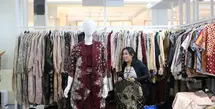 Tampil modis dengan gaya berwastra di masa kini. Bagian depan, sebuah manekin mengenakan setelan bernuansa merah marun dengan motif batik yang elegan, sementara di belakangnya deretan pakaian dengan beragam warna dan motif tertata rapi di gantungan. (Foto: Parade Wastra.doc)