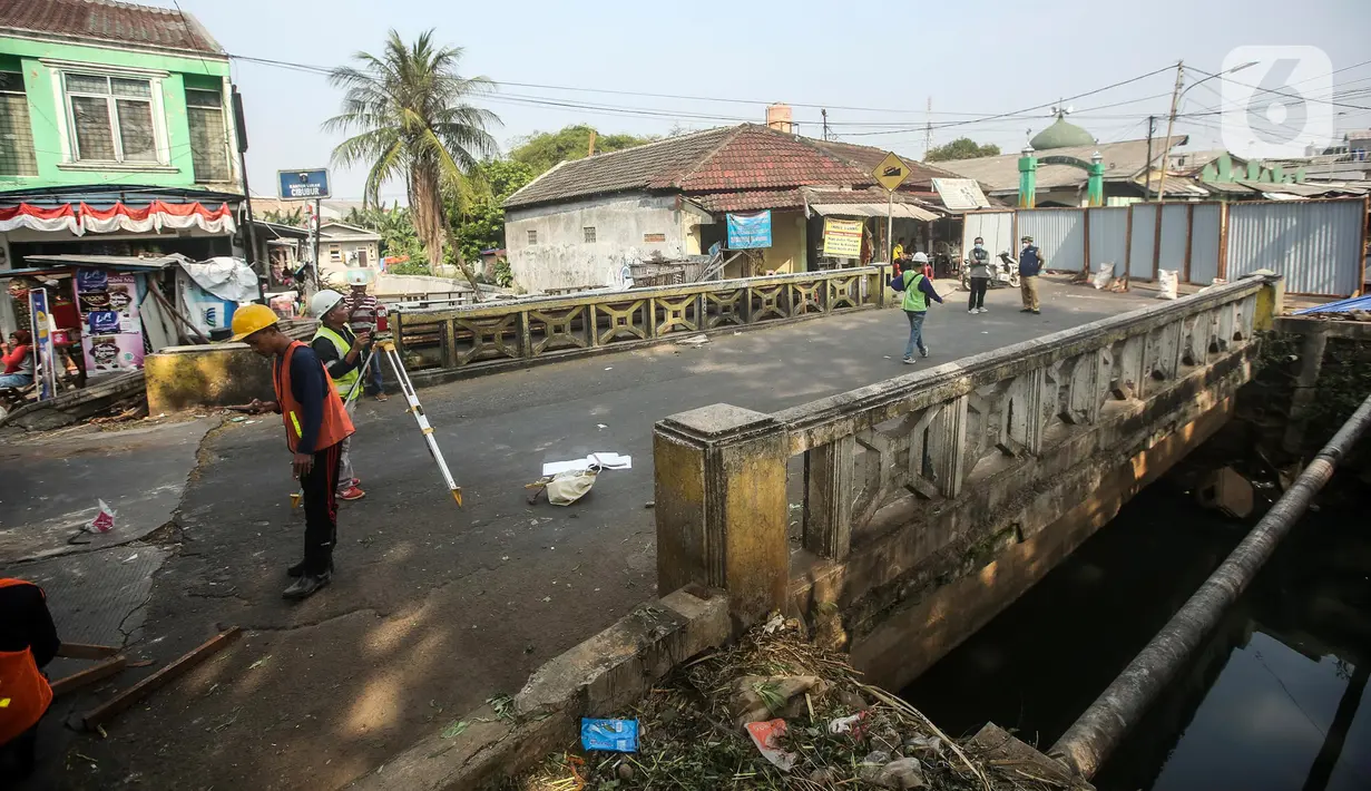 Pekerja menyelesaikan proyek revitalisasi Jembatan Cibubur, Jakarta, Selasa (2/8/2022). Revitalisasi dilakukan untuk mengantisipasi risiko banjir akibat rendahnya muka jembatan serta risiko kecelakaan akibat tidak adanya trotoar. (Liputan6.com/Faizal Fanani)