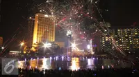 Warga saat menikmati malam tahun baru dengan dengan pertunjukan kembang api di Bundaran HI, Jakarta, Jumat (1/1/2016) malam. Kemeriahan kembang api tersebut merupakan bentuk perayaan pergantian tahun 2015 menuju 2016. (Liputan6.com/Angga Yuniar)