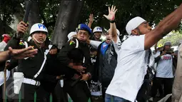 Polisi Militer Angkatan Laut menangkap seorang pria yang diduga provokator dalam aksi damai 2 Desember di kawasan Monas, Jakarta, Jumat (2/12). Pria ini sempat dipukuli hingga mengalami luka di bagian kepala. (Liputan6.com/Gempur M Surya)